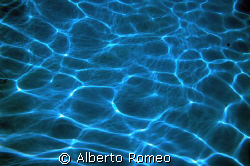 REFRACTION OF SUN RAYS ON THE SAND BOTTOM IN SHALLOW WATERS by Alberto Romeo 
